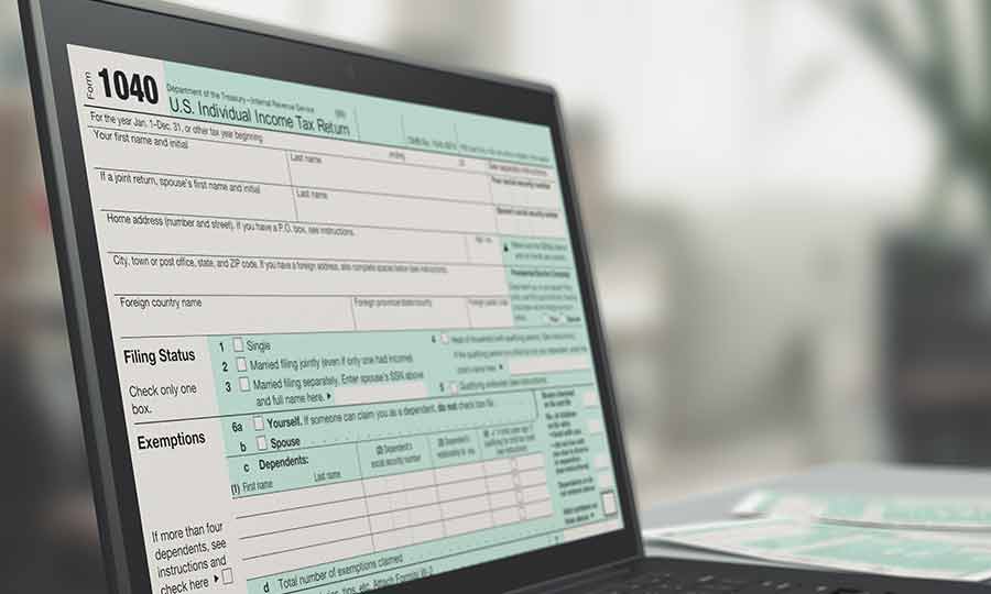 A laptop screen showing a 1040 tax form